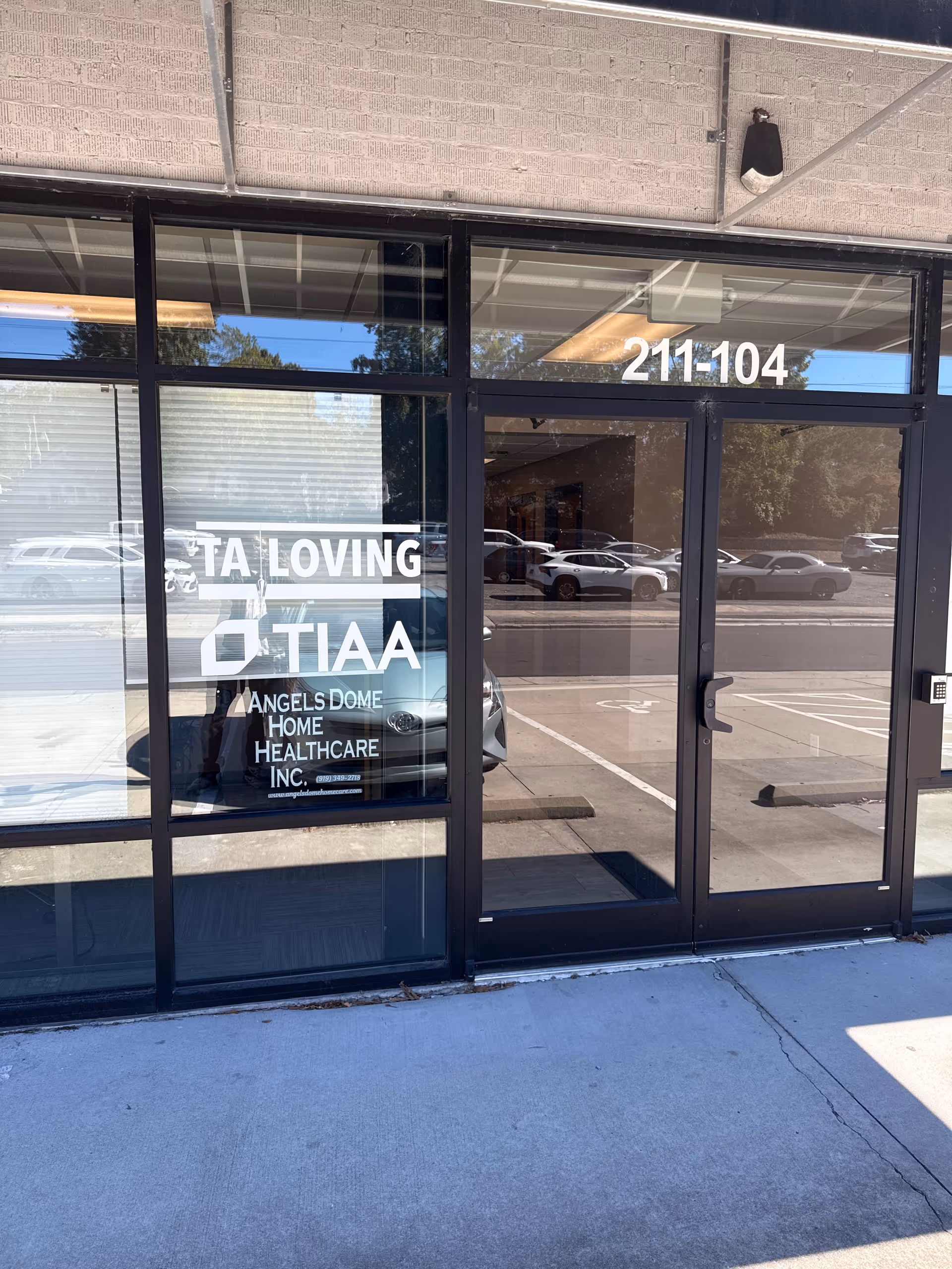 Glass storefront entrance displaying Angels Dome Home Healthcare signage with reflected cars.