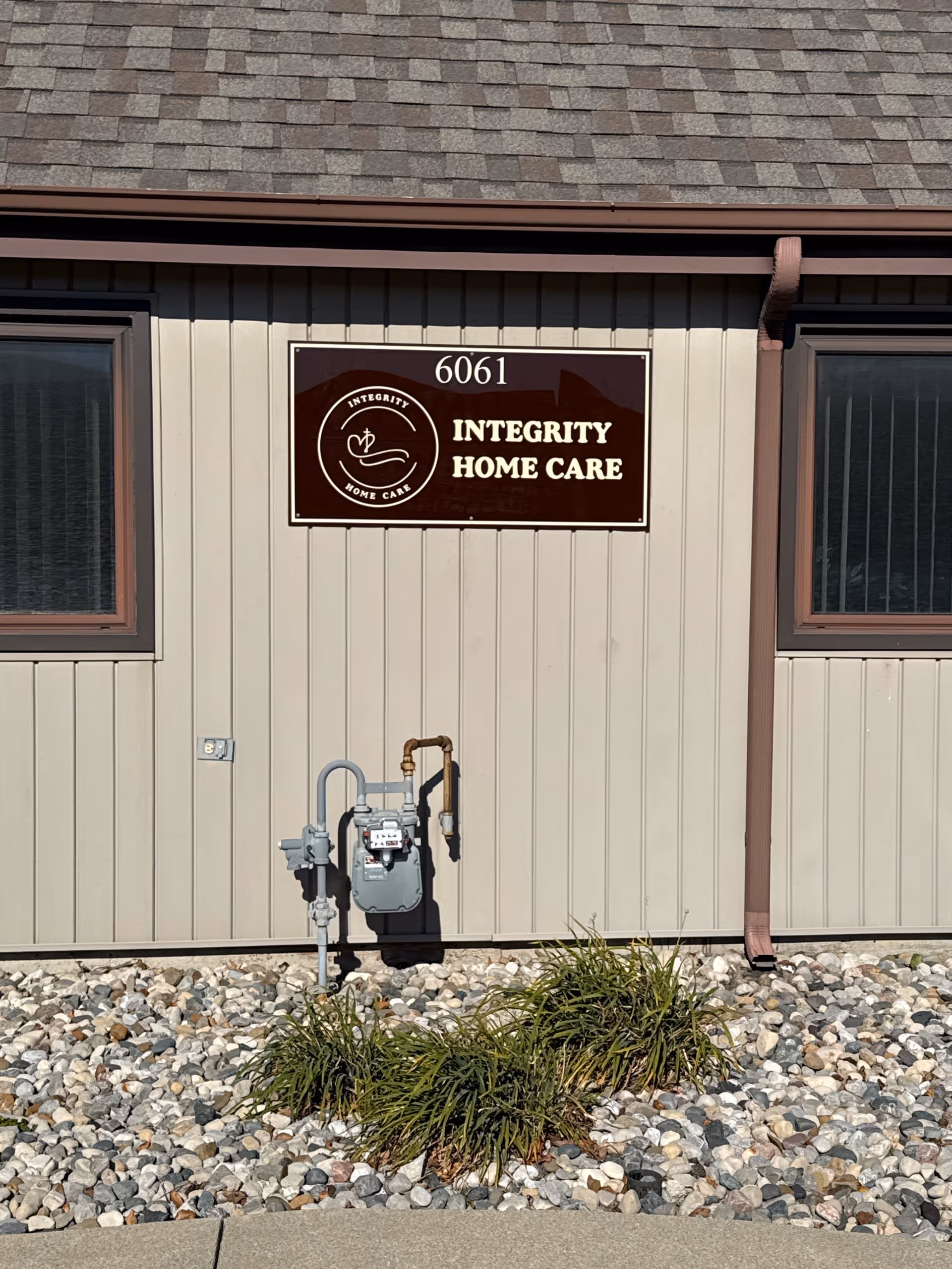 Exterior view of Integrity Home Care building with sign and utility meters.