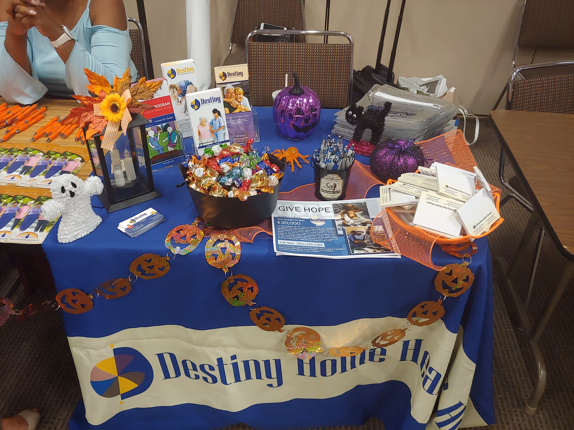 Indoor promotional table displaying Destiny Home Health materials and decorations.