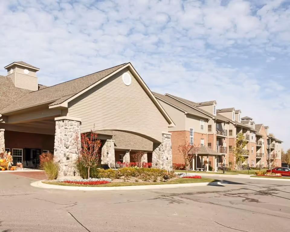 Exterior view of Abbey Park at Mill River, a multi-building senior living campus.