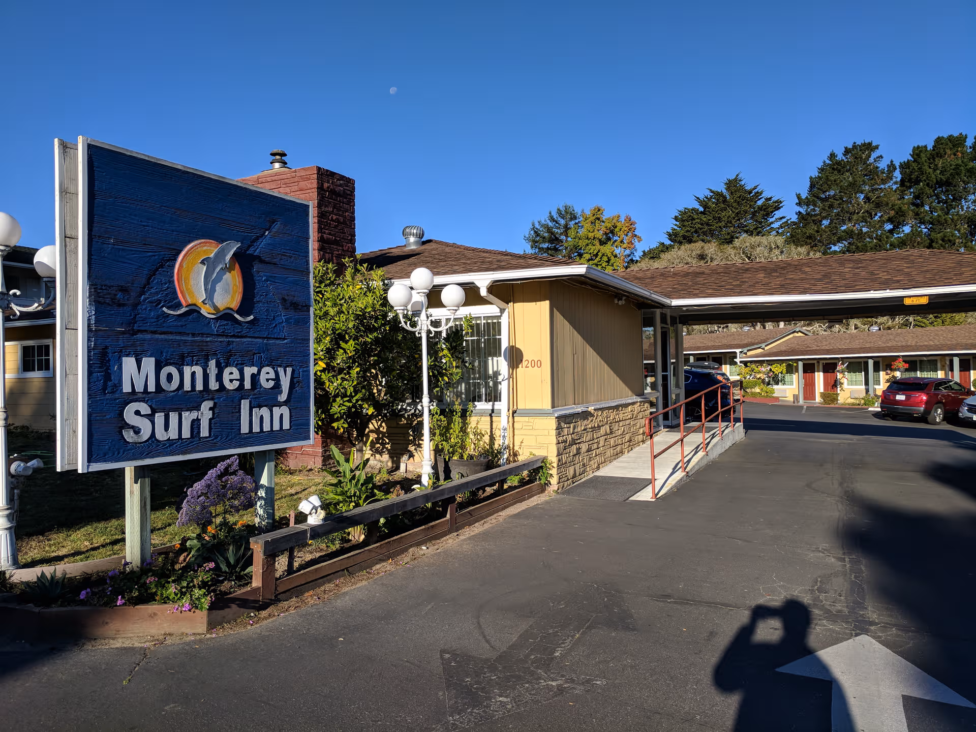 Exterior view of Ivy Park at Monterey with a blue sign and driveway entrance.