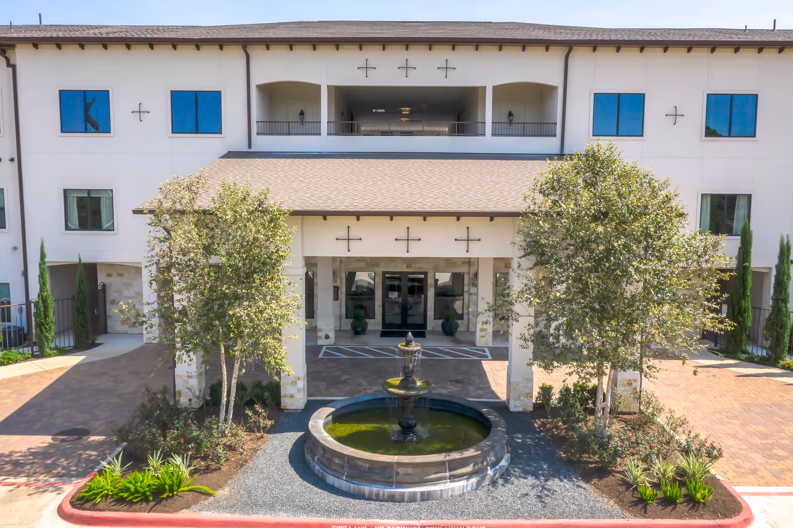Exterior view of Solea Copperfield senior living facility with central fountain courtyard