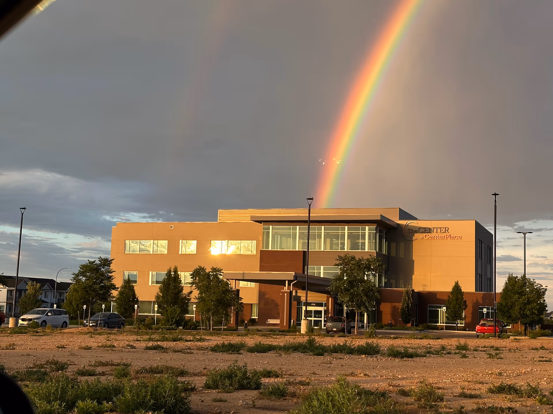 Exterior view of The Center at CenterPlace with a rainbow in the sky