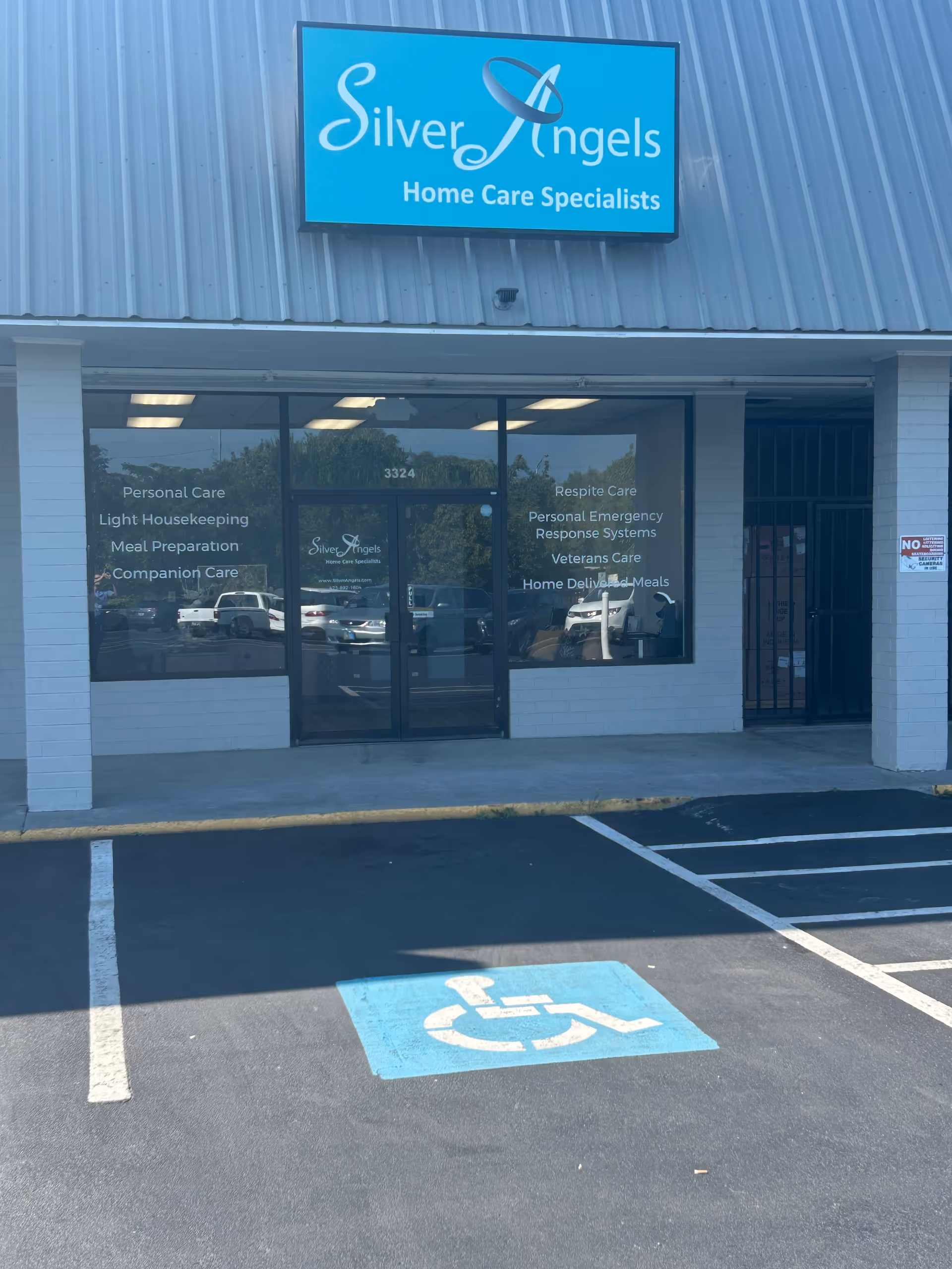 Front view of Silver Angels Home Care storefront with glass doors and handicap parking.