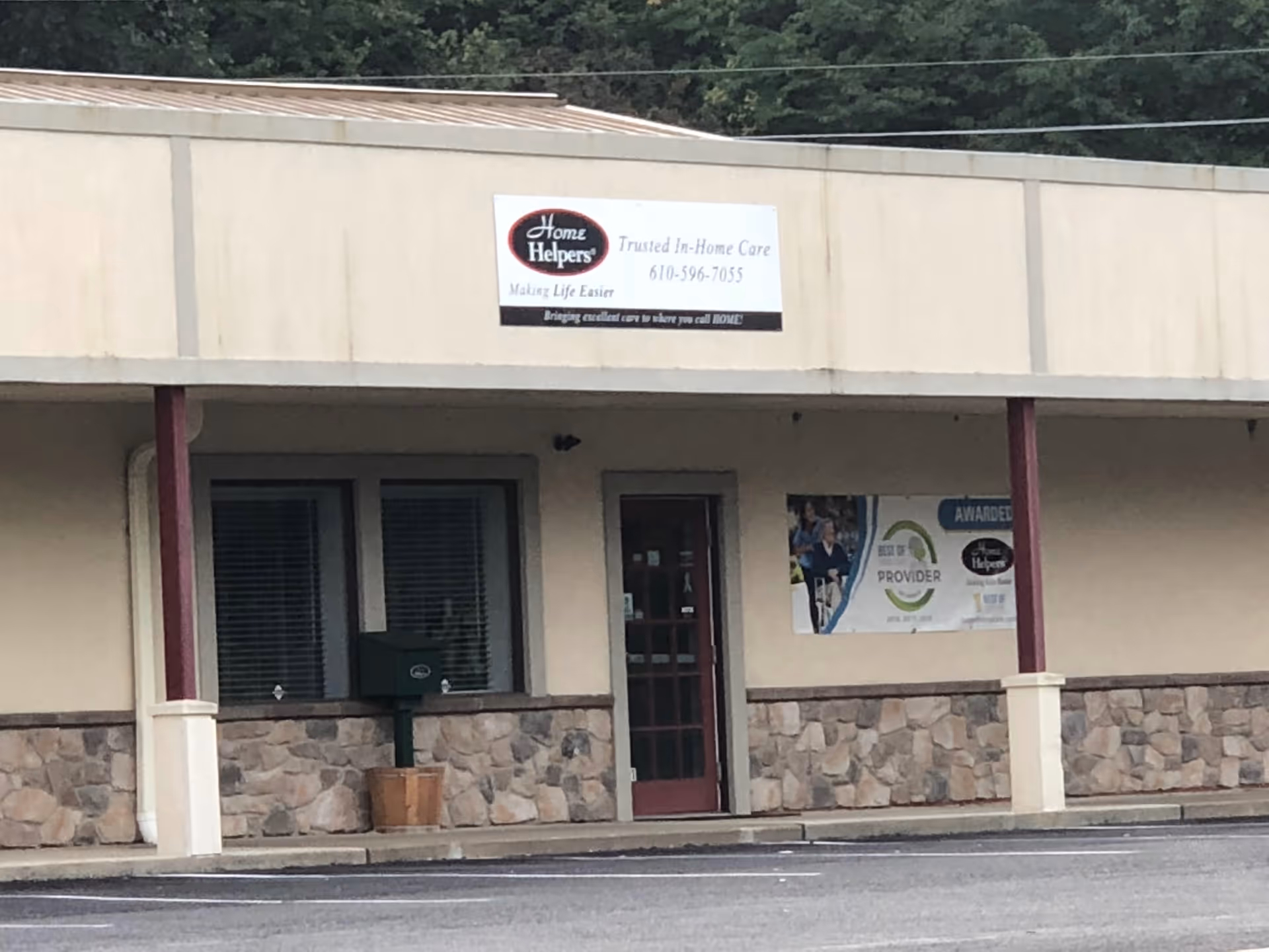 Front view of Home Helpers facility with sign, windows, and entrance.