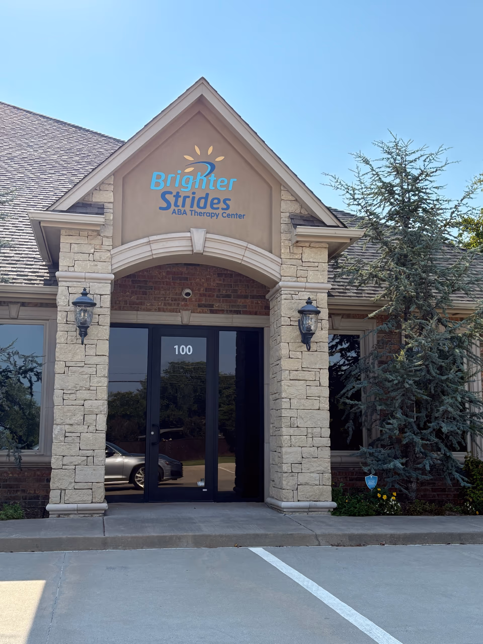 Front entrance of Brighter Strides ABA Therapy Center with stone facade and glass doors