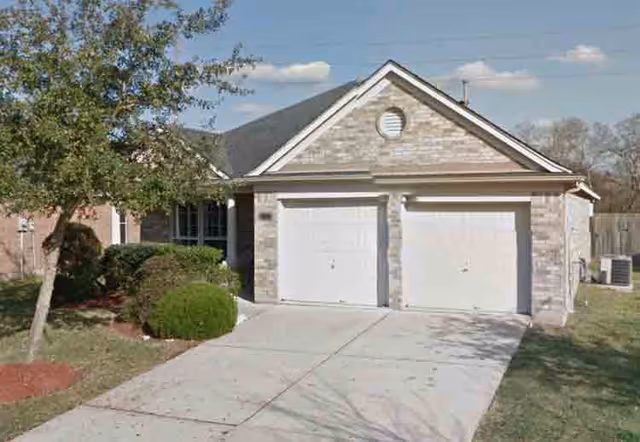 Front view of Faith Personal Care Home #1, showing a brick two-car garage residence.