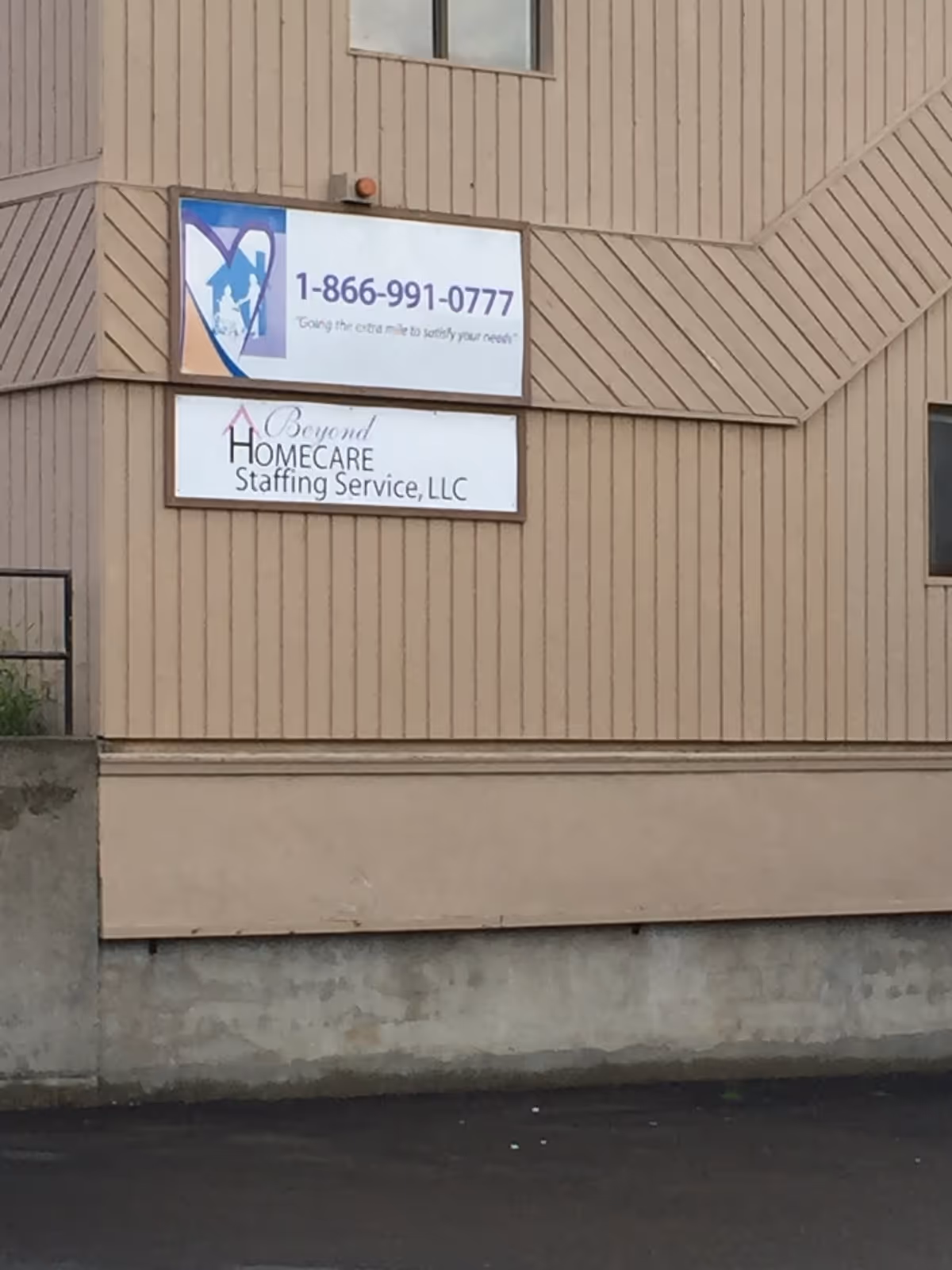 Exterior view of a beige building with two signs for Beyond HomeCare Staffing Services.