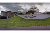 Exterior view of a low-brick facility with a curved sign reading Samaritan Place Catholic Charities