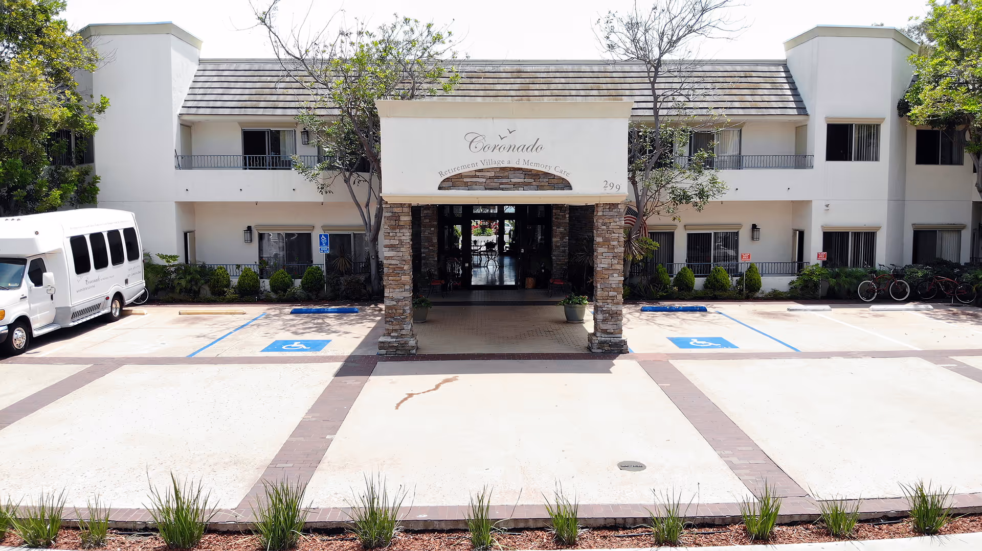 Exterior view of Coronado Retirement Village entrance with accessible parking.