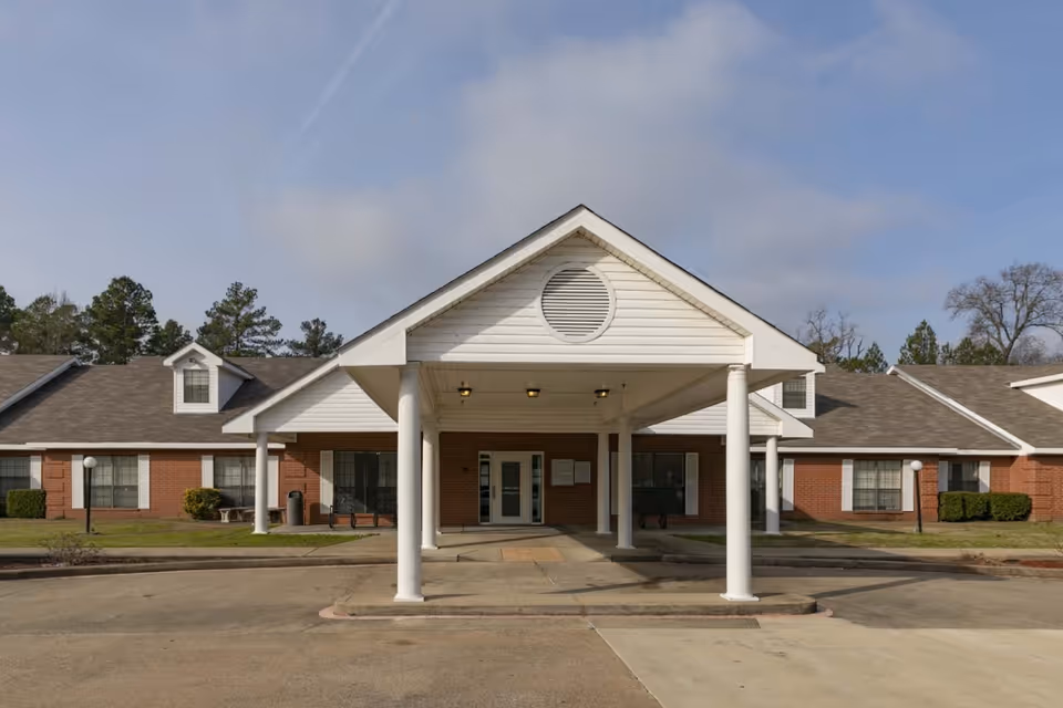 Front view of a Legend Oaks Gladewater senior living facility with a covered entrance.