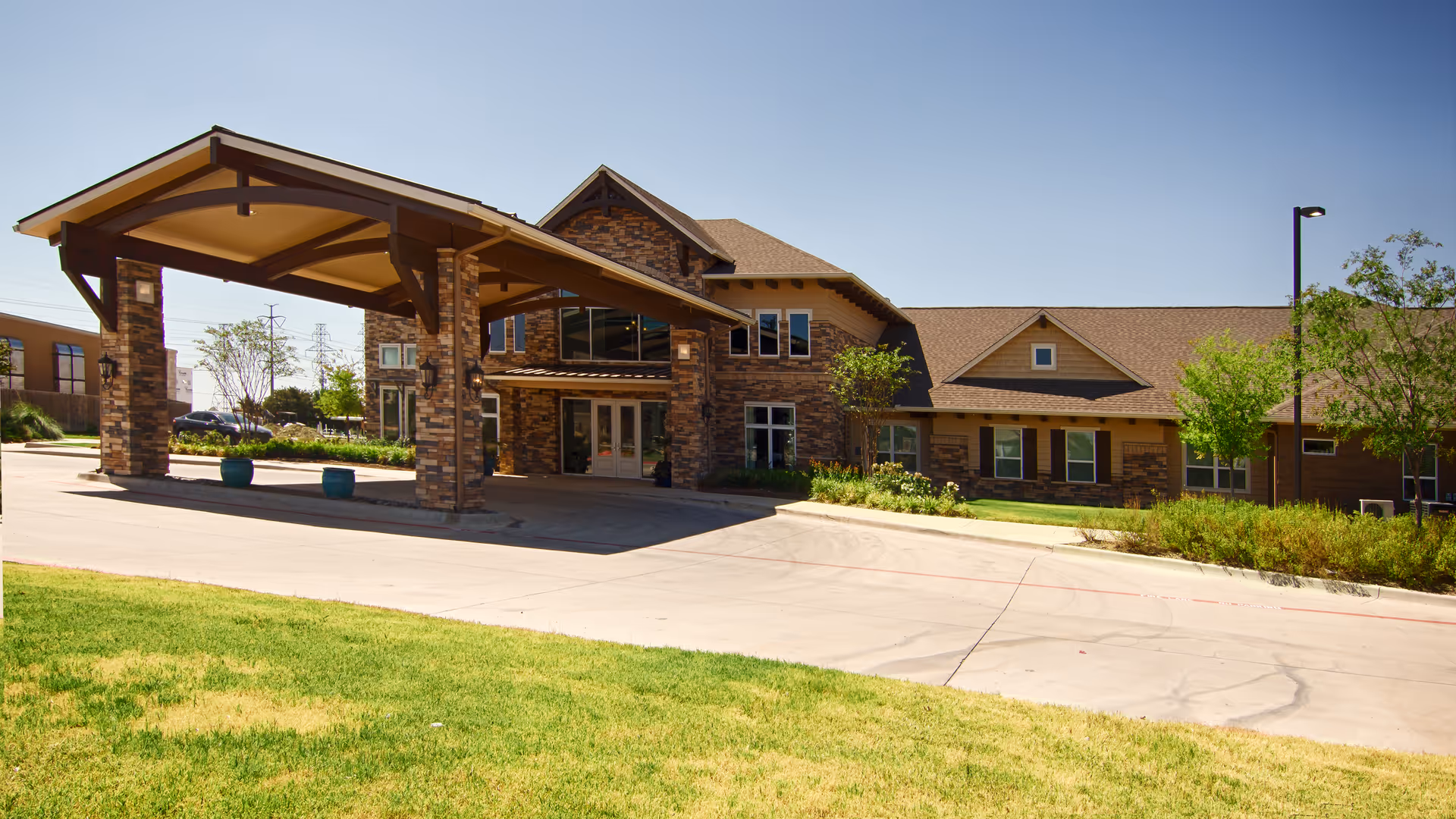 Exterior view of Bristol Park at Eagle Mountain showing the front entrance and covered drop-off