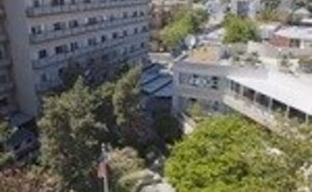 Aerial view of Piedmont Gardens exterior with surrounding trees and multiple connected buildings.