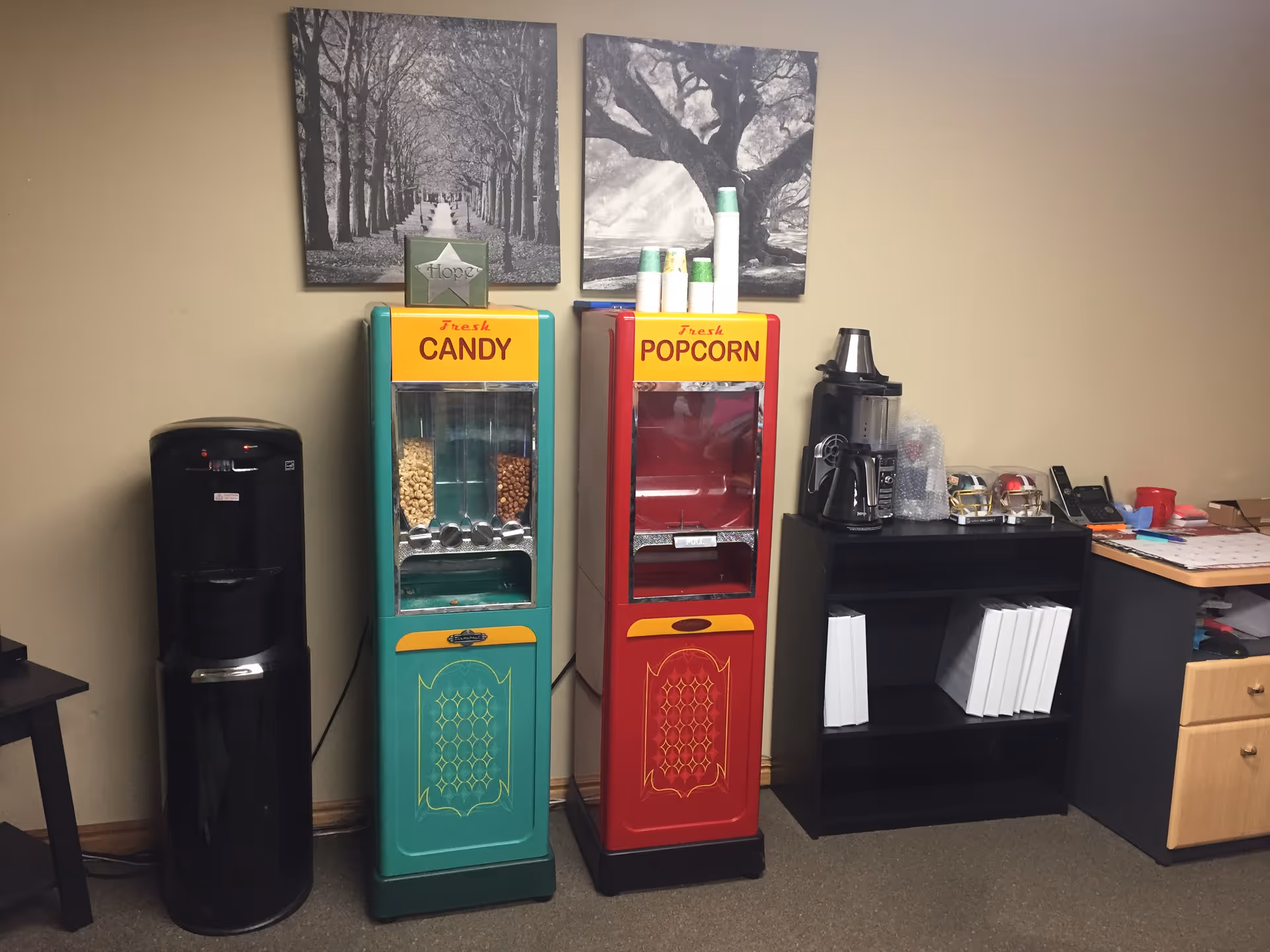 Interior break area with candy and popcorn vending machines beside a coffee station.