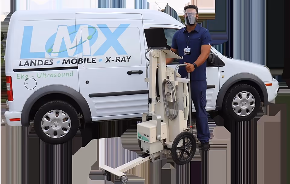Healthcare worker in scrubs stands beside a Landes Mobile X-ray van and unit.