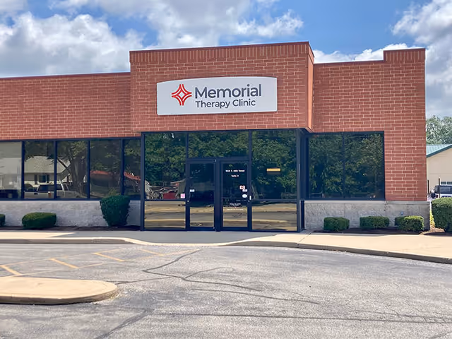 Brick storefront with Memorial Therapy Clinic sign and glass doors.