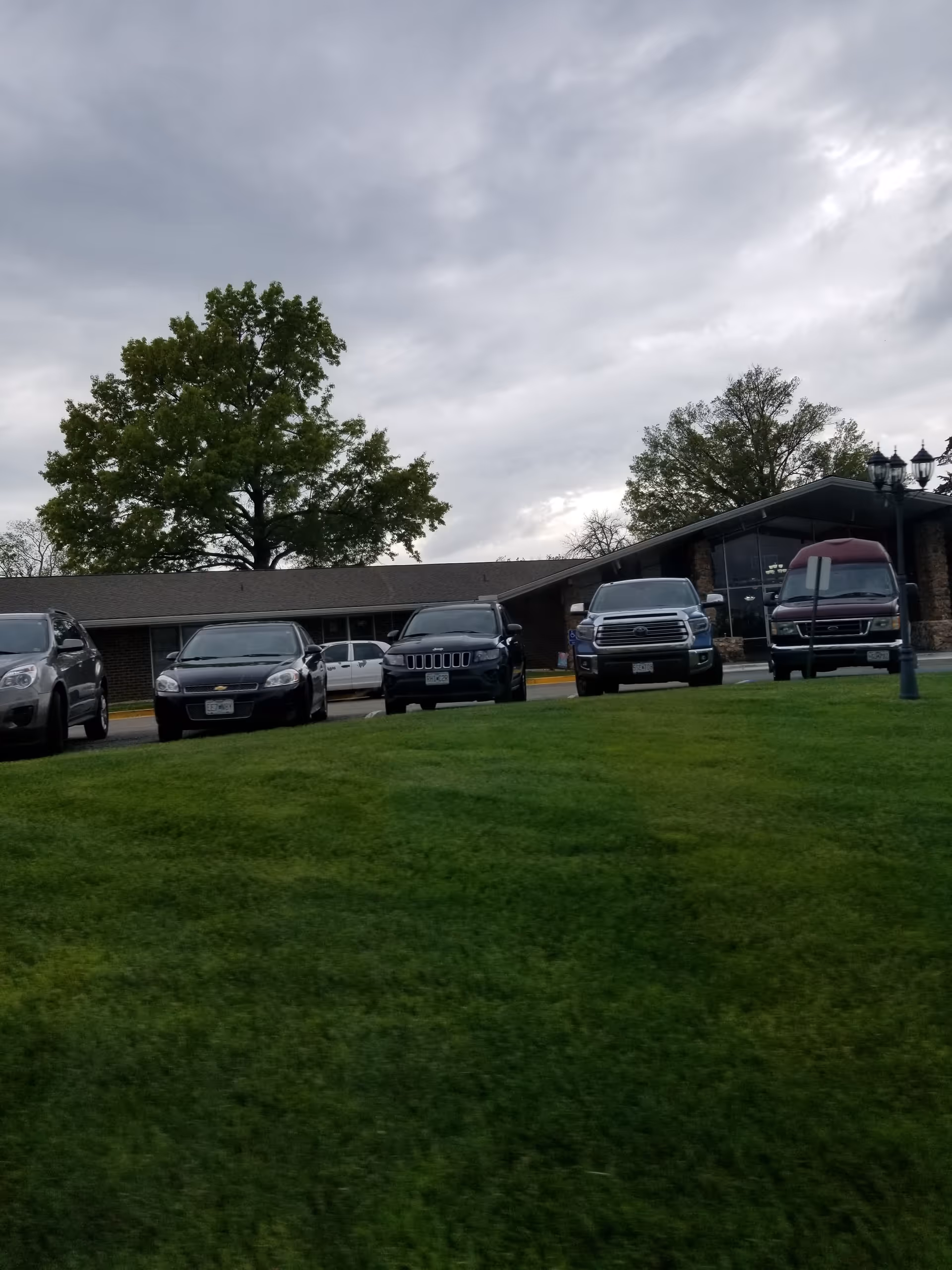 Exterior view of Adams Street - A Stonebridge Community with parked cars in front.