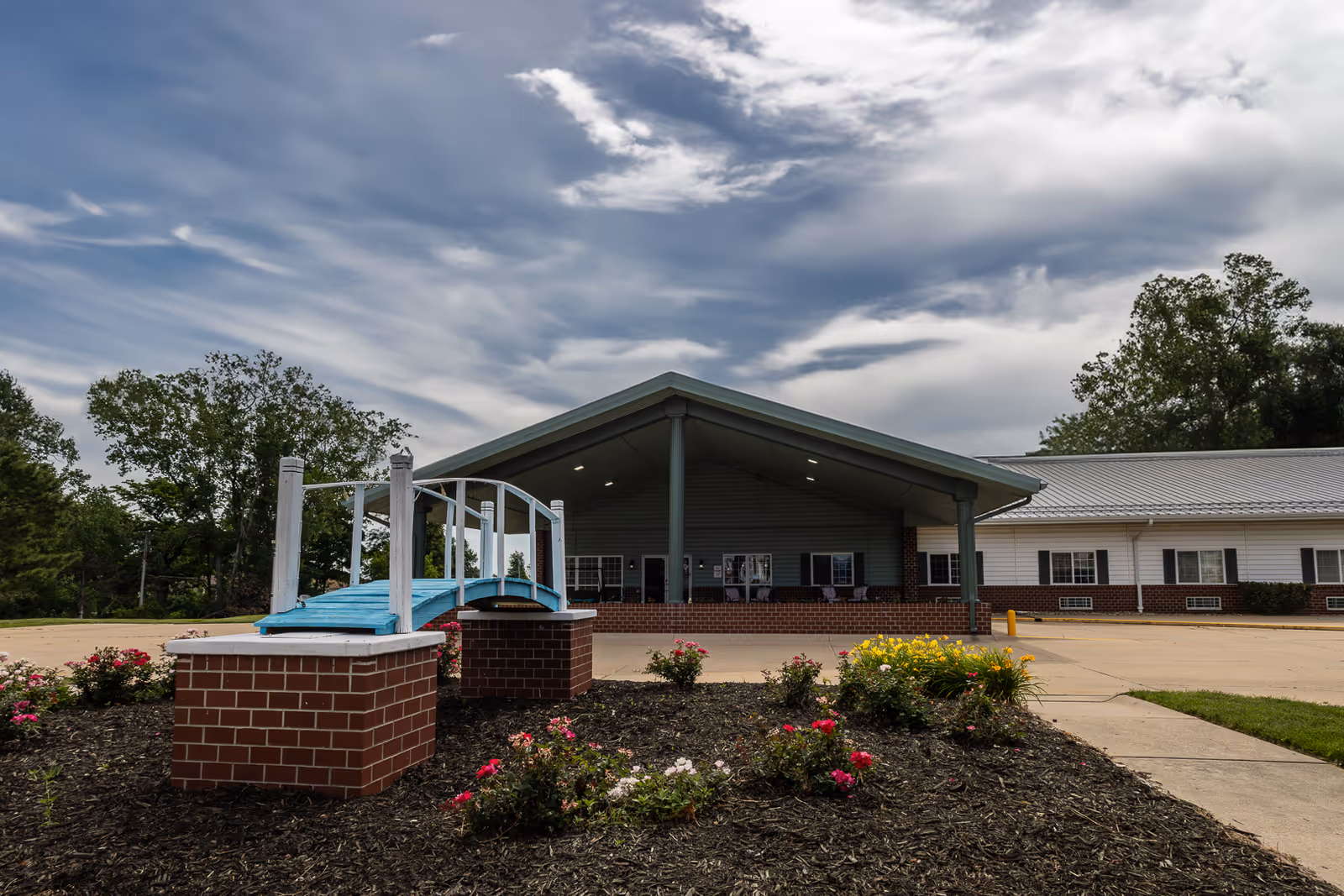 Exterior view of Bailey Pointe at Plattsmouth entrance with brick facade, canopy, and landscaping.