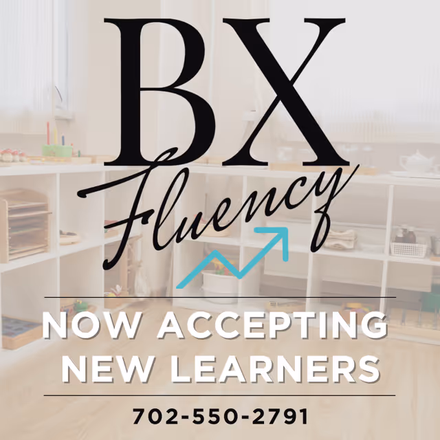 Interior classroom-like space with cubby shelves and learning materials, branded BX Fluency.