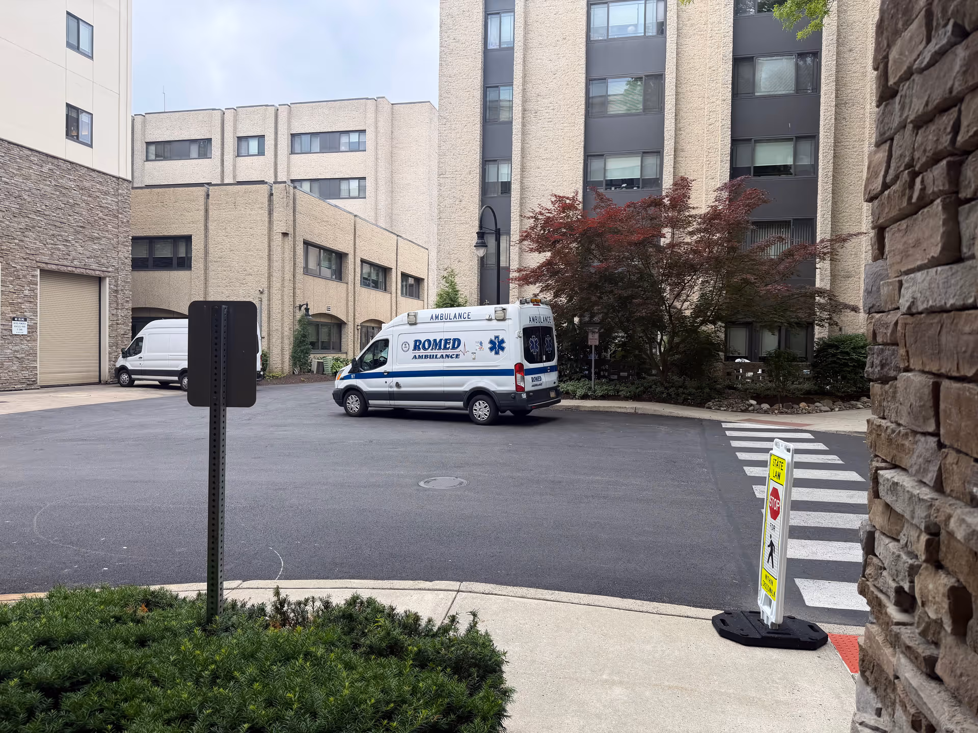 Ambulance parked in the driveway at Rydal Park & Waters senior living facility exterior.