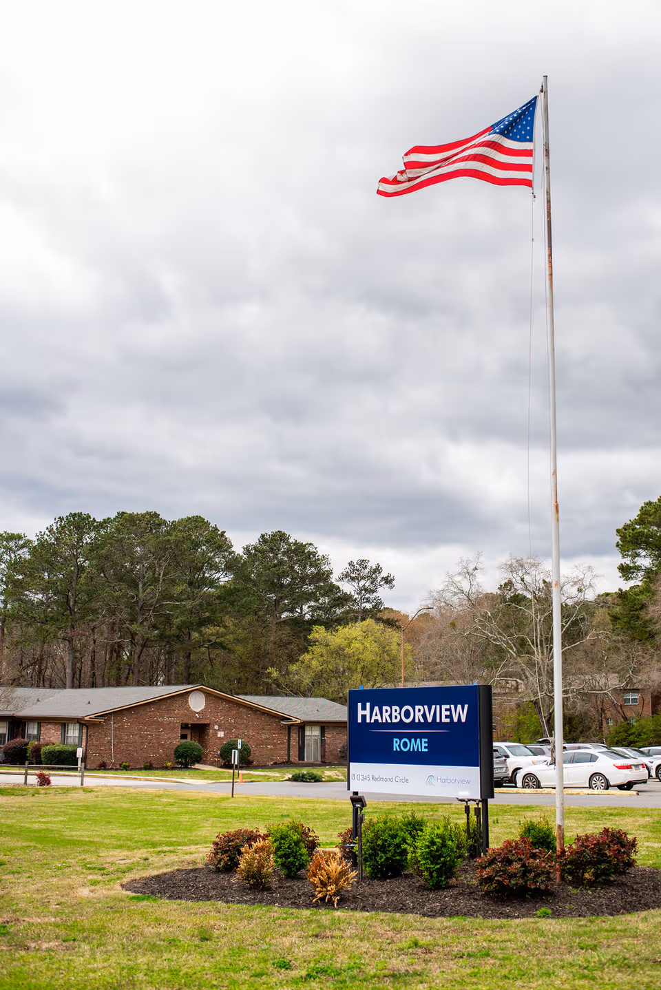 Exterior view of Harborview Rome facility with flagpole and front sign.
