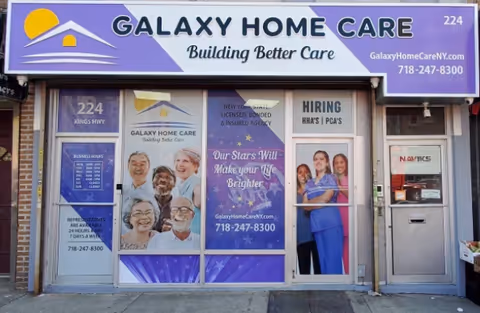 A Galaxy Home Care NYC storefront displays a purple sign and elderly care posters.