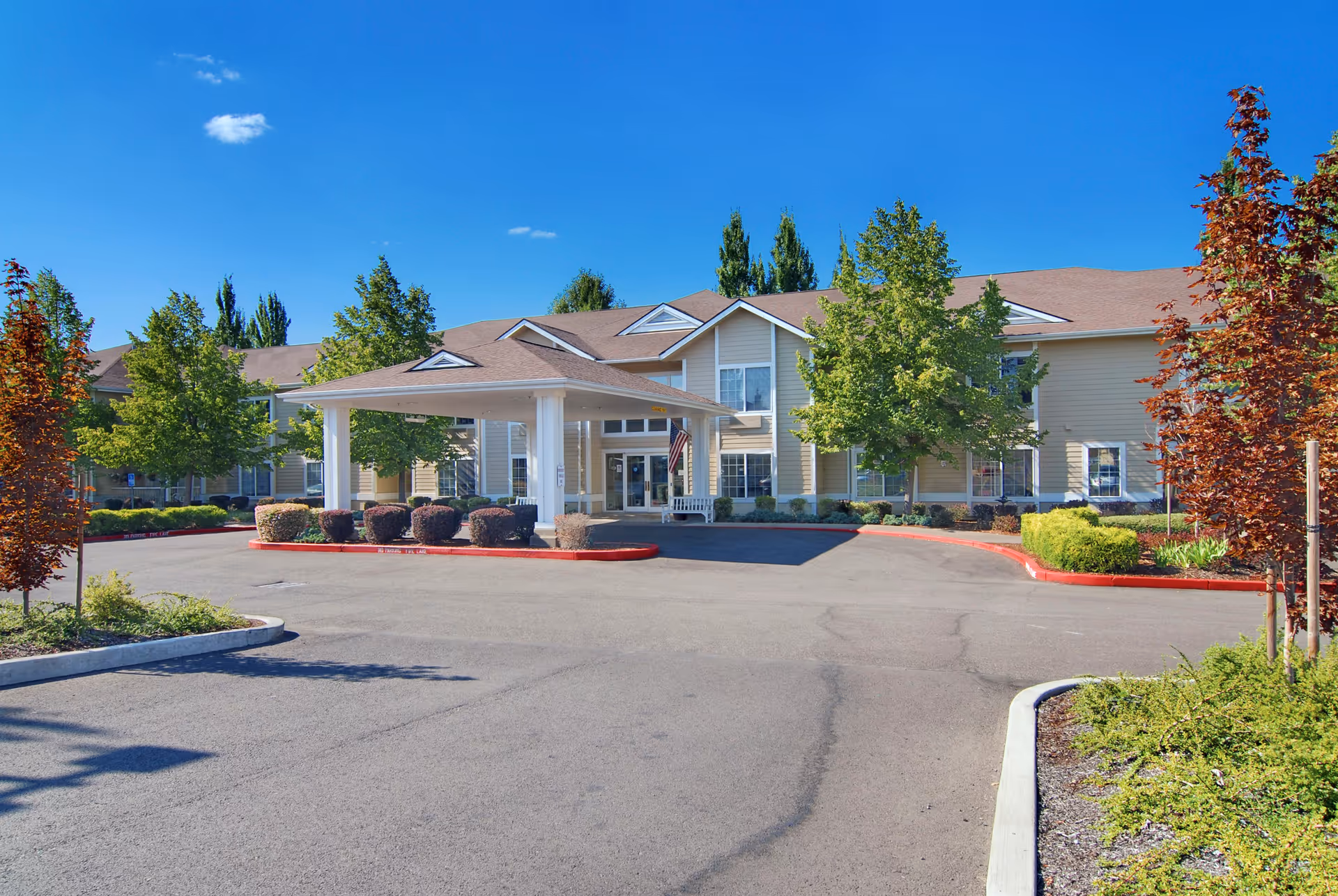 Exterior view of a Brookdale senior living facility with covered entrance and landscaped surroundings.