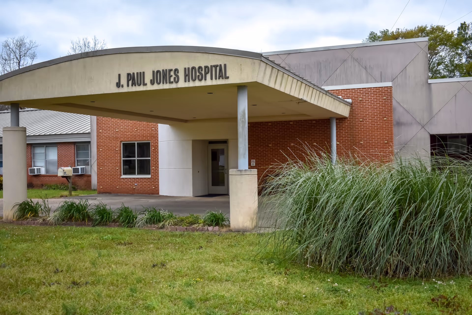 Front view of J. Paul Jones Hospital entrance under a curved canopy.