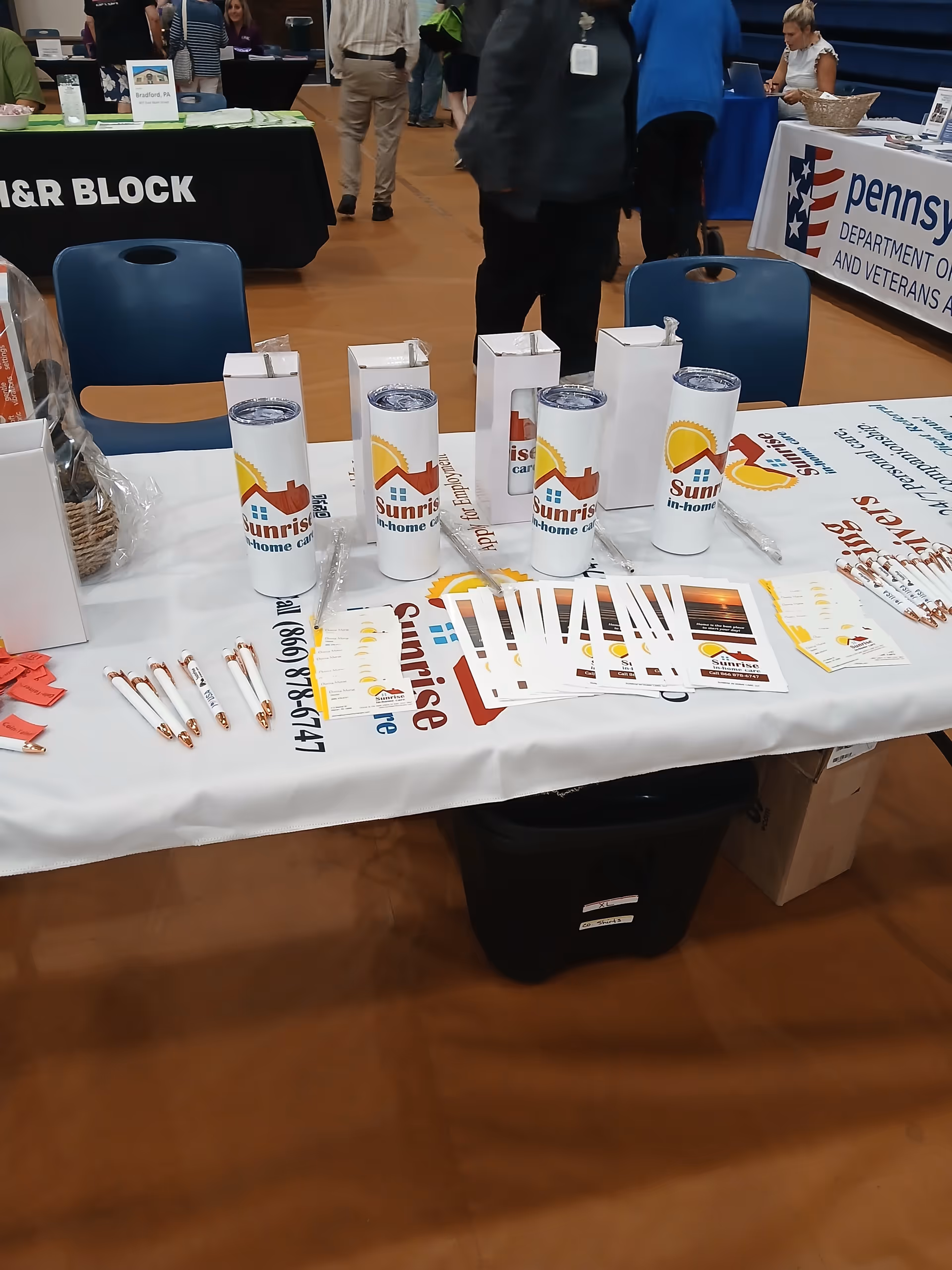 Sunrise In-Home Care booth with branded cups and brochures at a convention