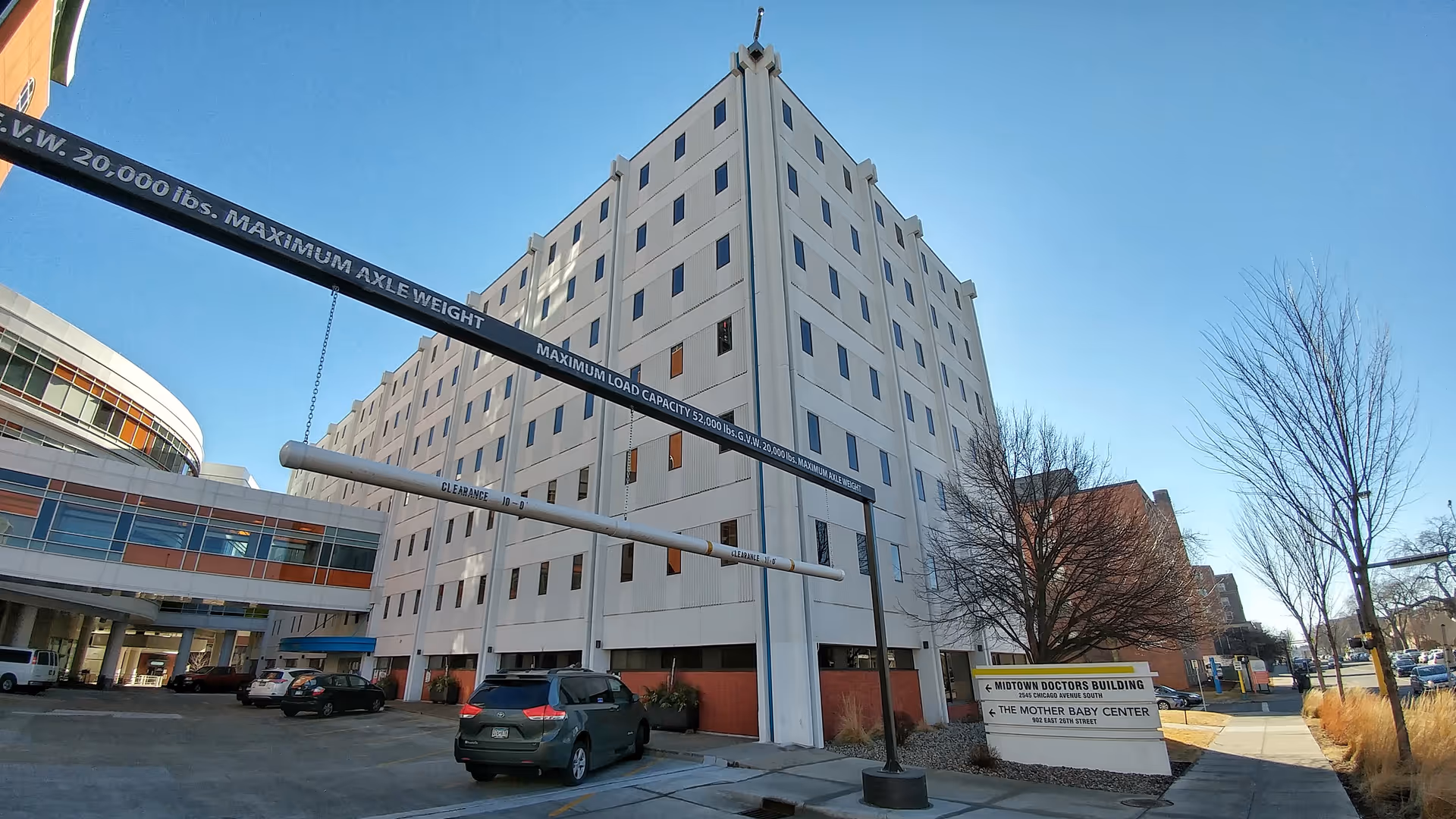 Exterior view of a large medical building with parking and Mother Baby Center signage.