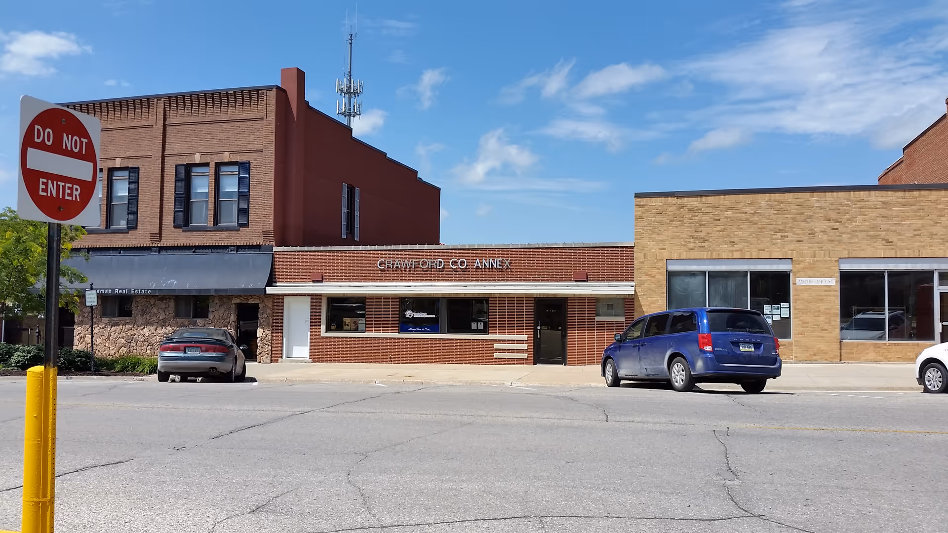 Street view of Crawford County Annex building with parked cars and a Do Not Enter sign.
