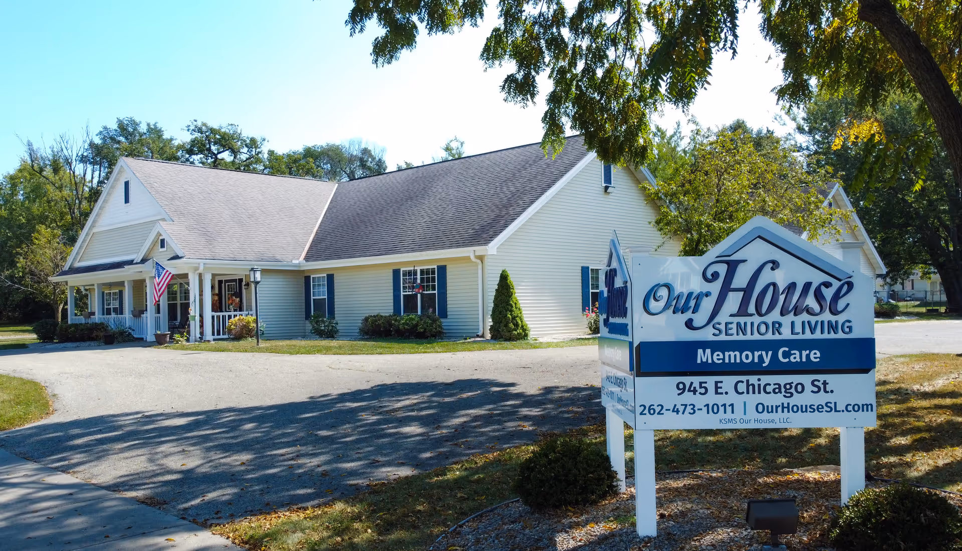 Front exterior of Our House Senior Living facility with a large sign.