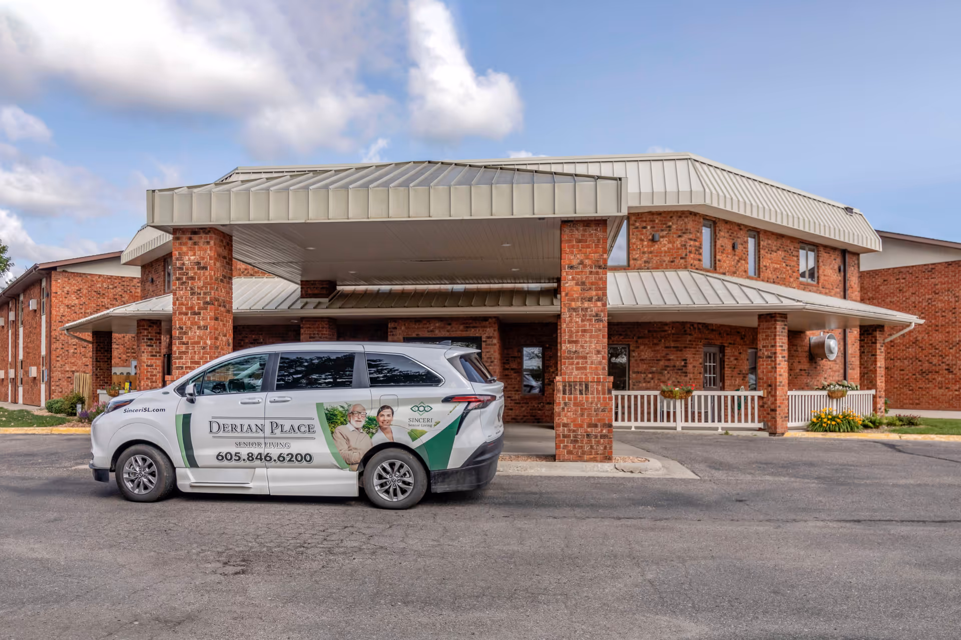 Derian Lodge Senior Living exterior with a branded van parked at the front entrance.