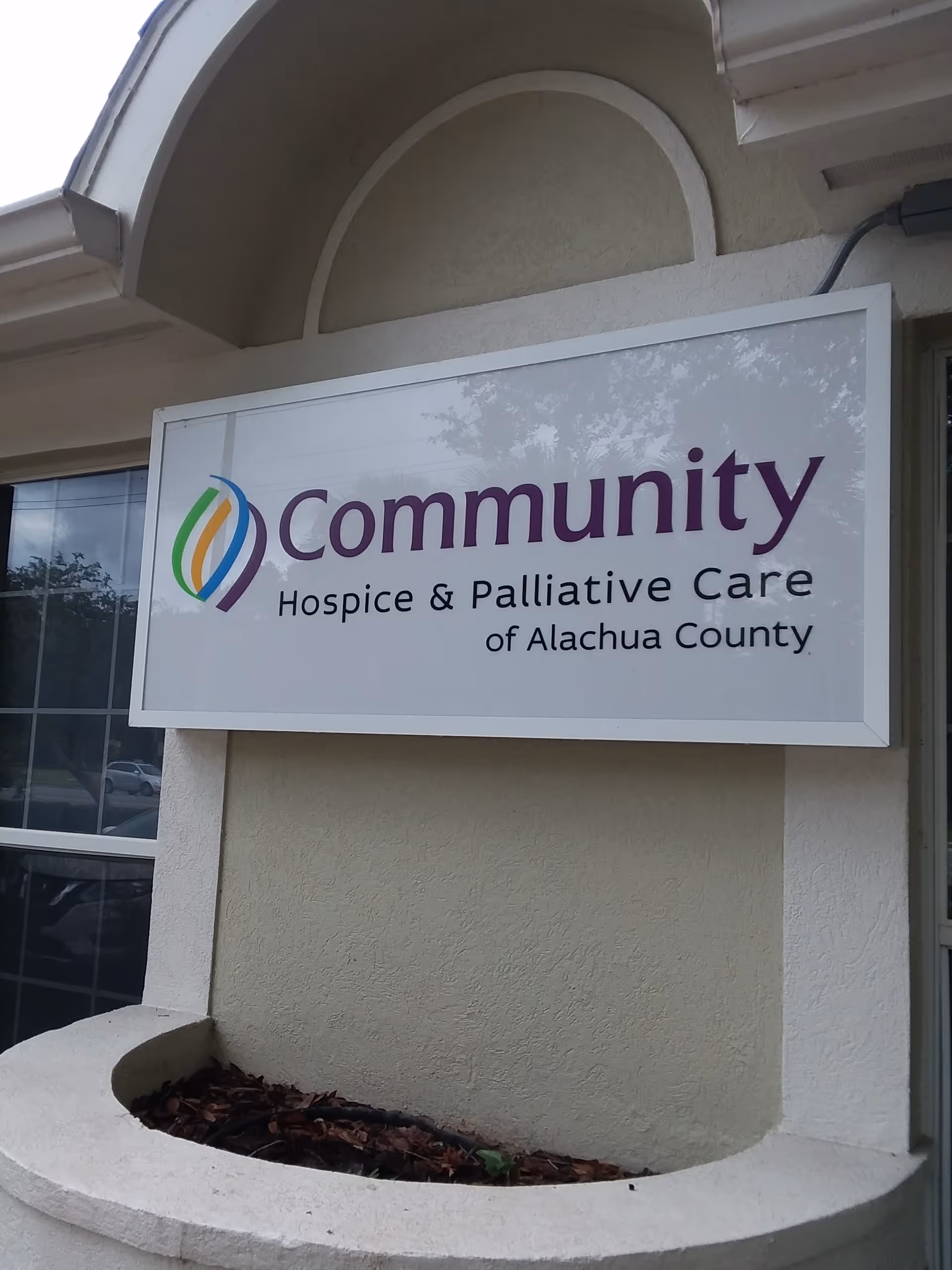 Exterior building sign displaying Community Hospice and Palliative Care of Alachua County.
