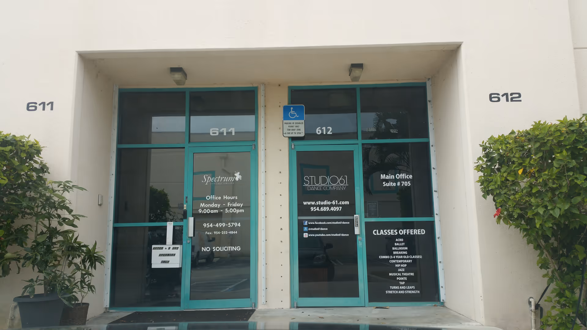 Exterior entrance to Spectrum Life Care Services with teal-framed glass doors and unit numbers 611-612.