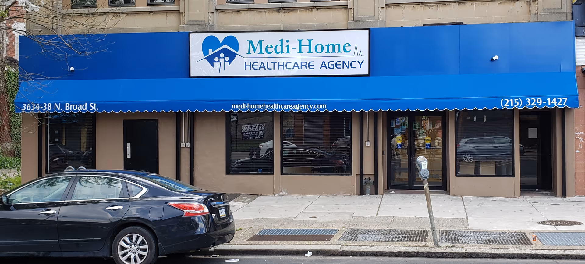 Blue storefront with Medi-Home Healthcare Agency sign and large windows along the street.