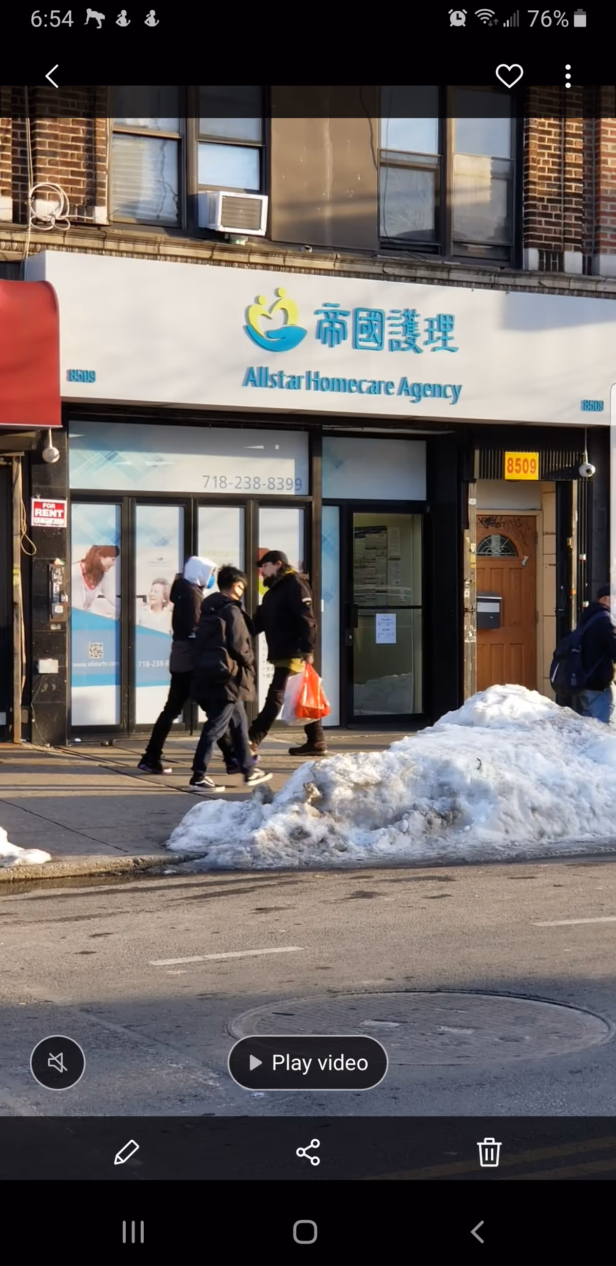 Exterior view of Allstar Homecare Agency storefront with pedestrians on a snowy sidewalk.