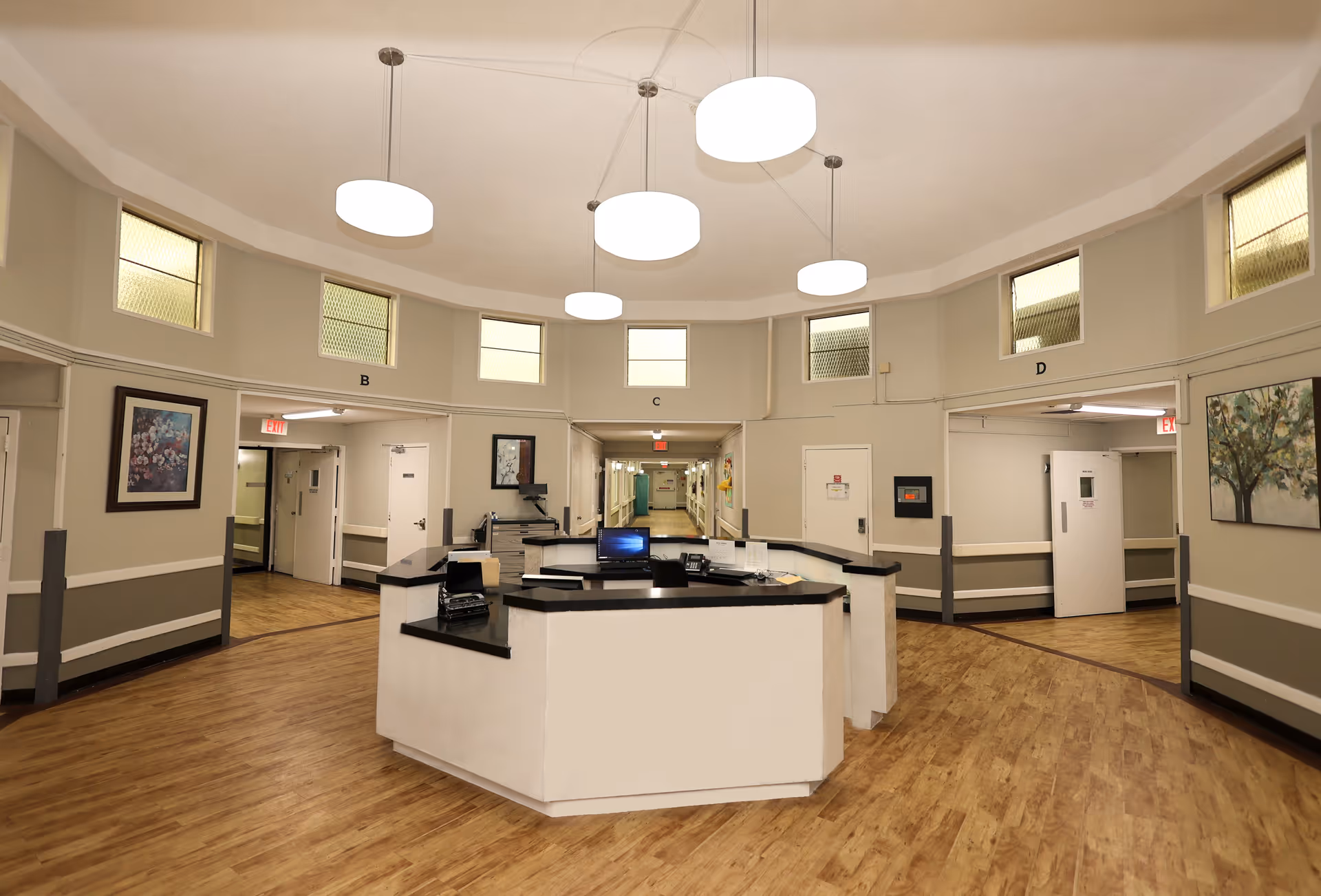 Circular reception desk in a spacious, well-lit senior living lobby.