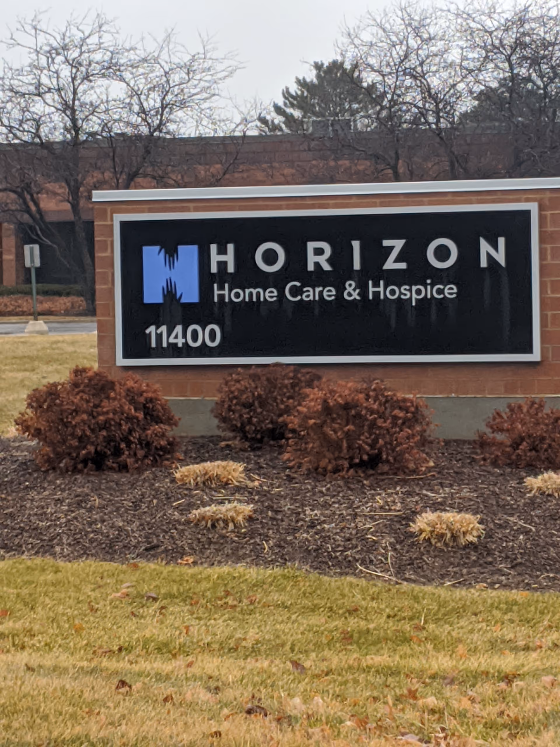 Horizon Home Care & Hospice sign on brick monument in front of facility.