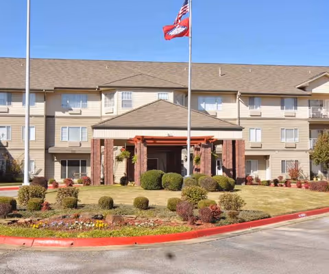 Exterior view of South Wind Heights facility with entrance canopy and manicured landscaping.