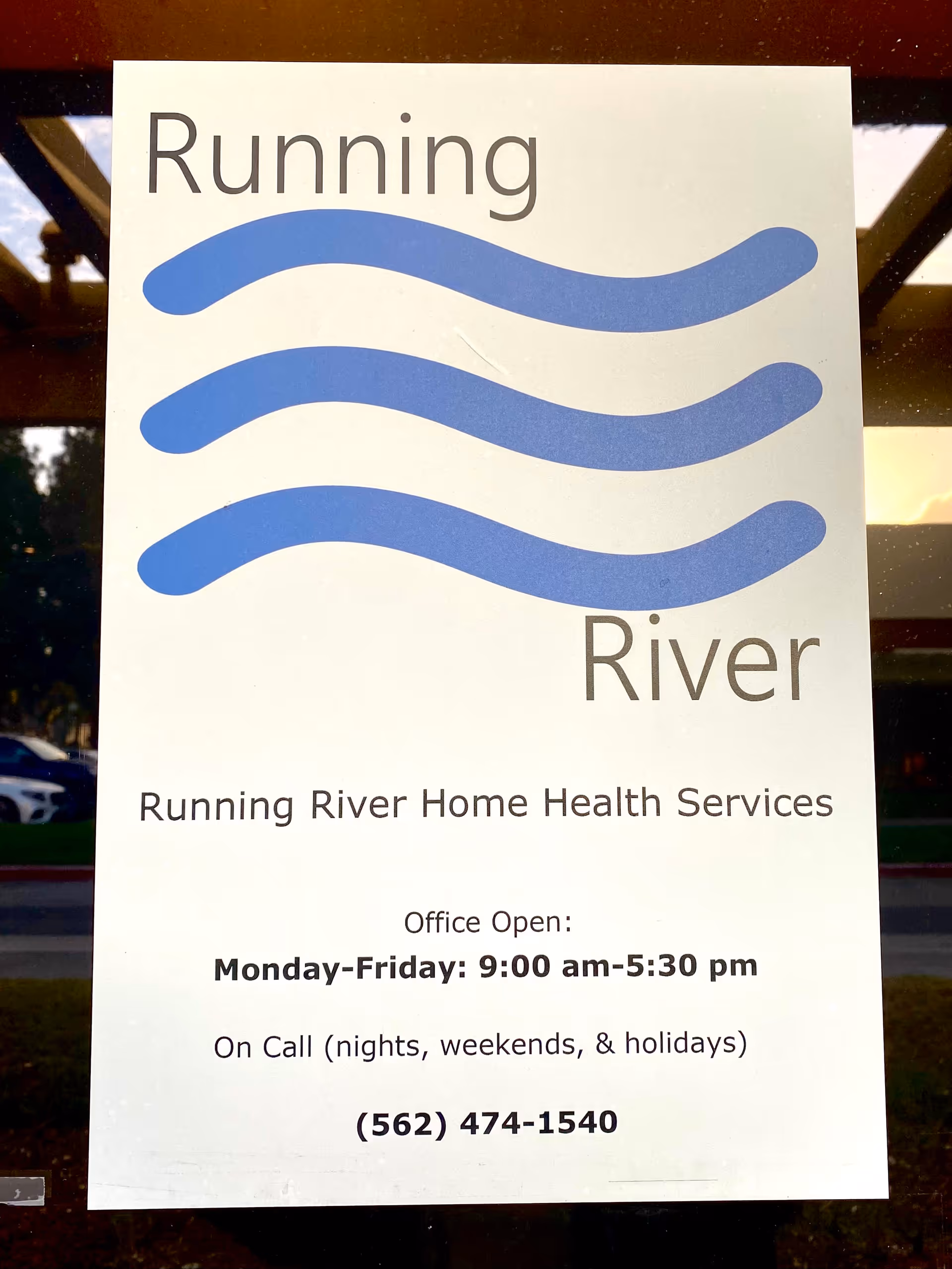 Exterior sign on a building displays Running River Home Health Services and hours.