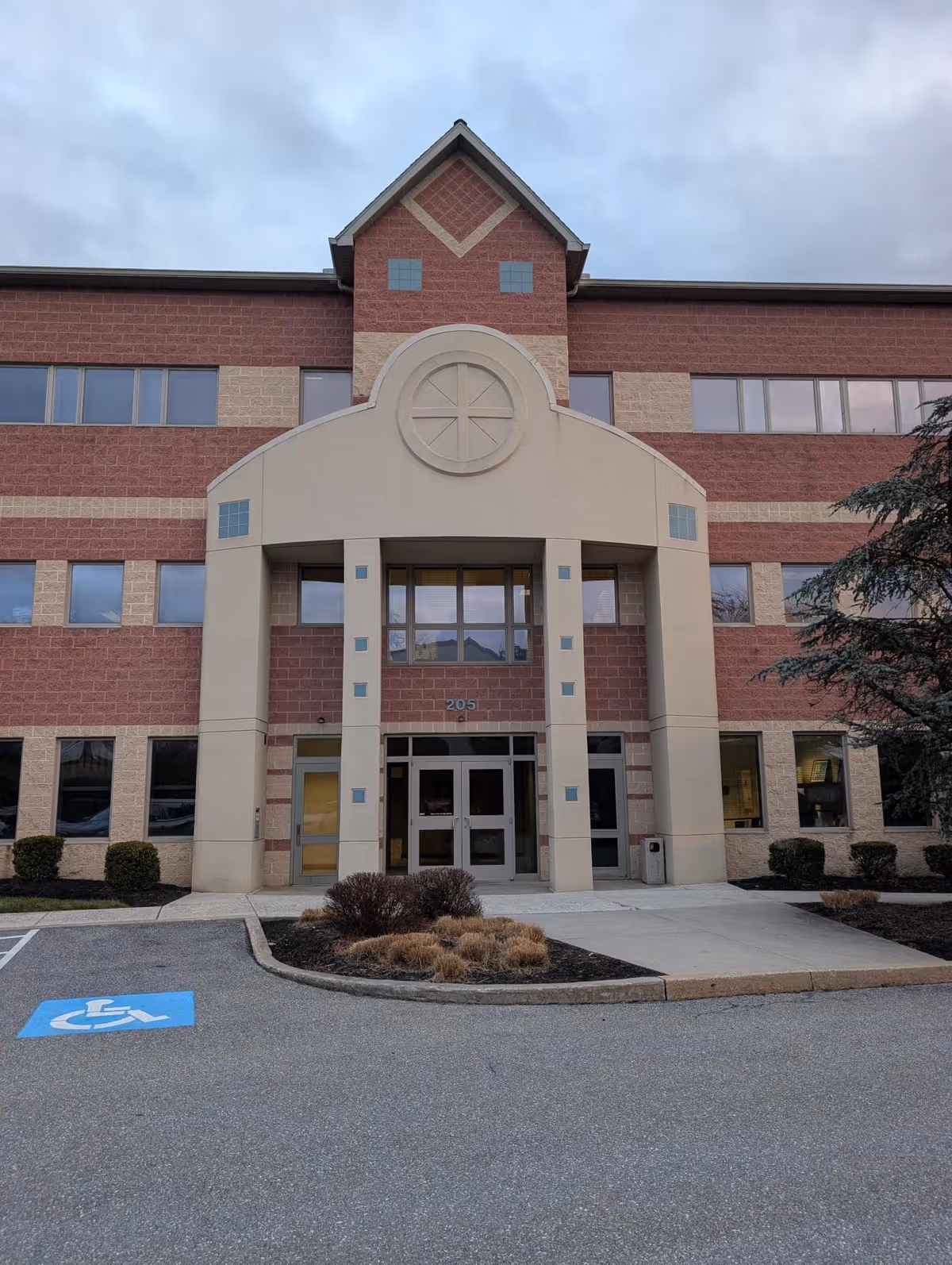 Front view of Serenity Hospice of Pennsylvania building with a covered entrance and brick facade.