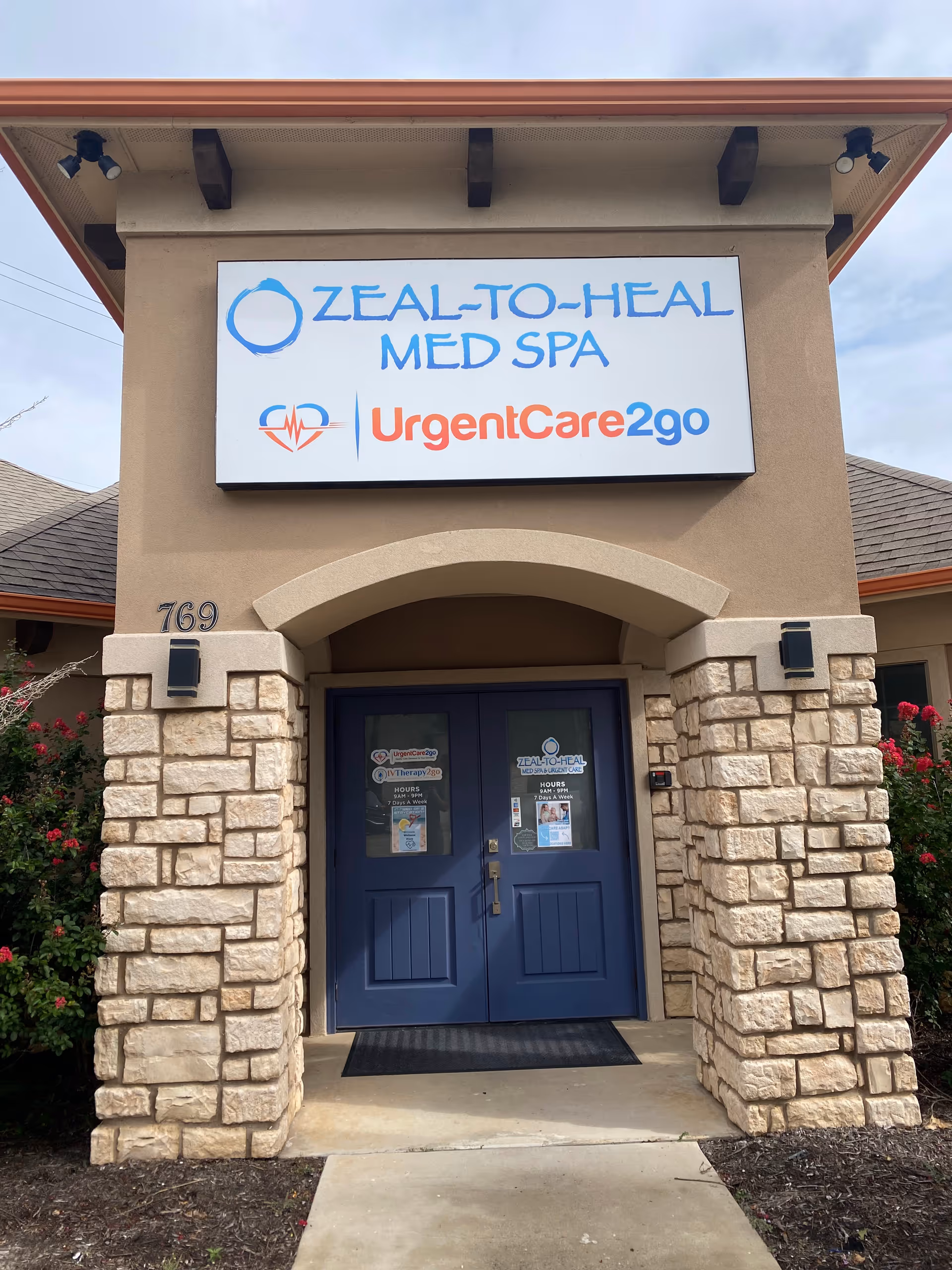 Front entrance of Zeal-To-Heal Med Spa and UrgentCare2go with blue doors