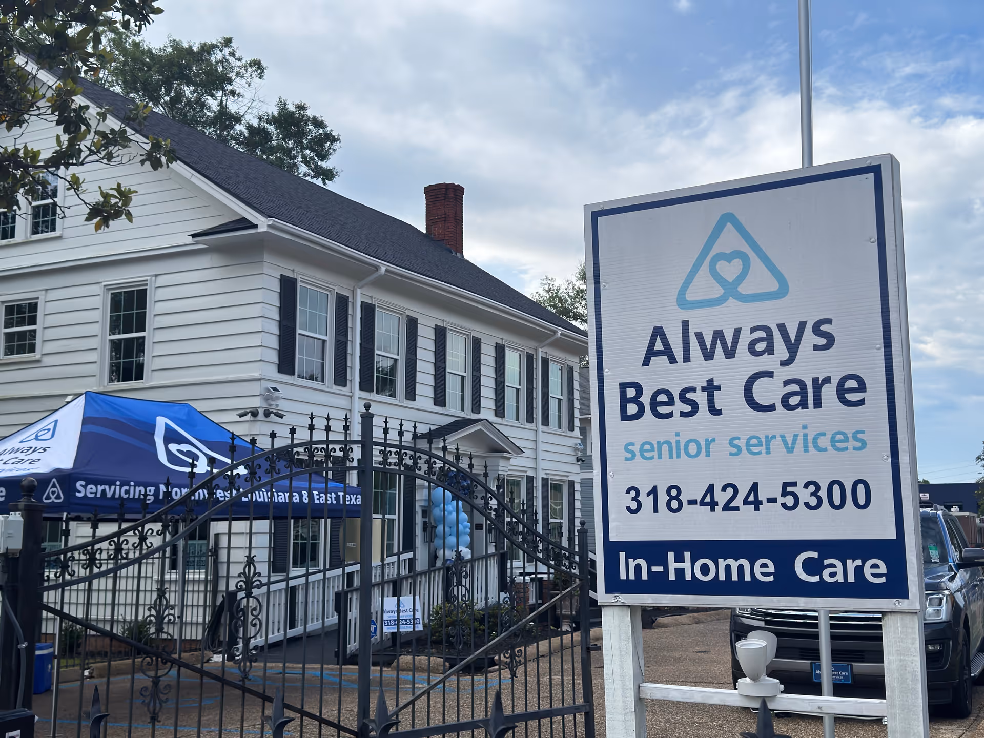 Exterior view of a white senior care building with a large Always Best Care sign.