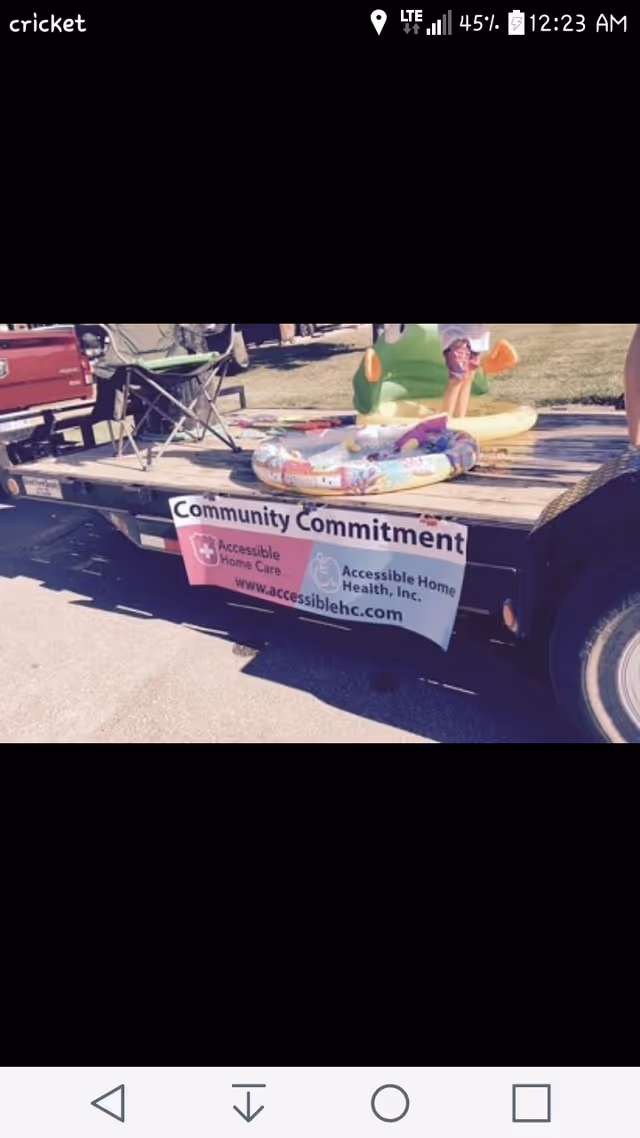 Outdoor trailer with an Accessible Home Care banner at a community event.
