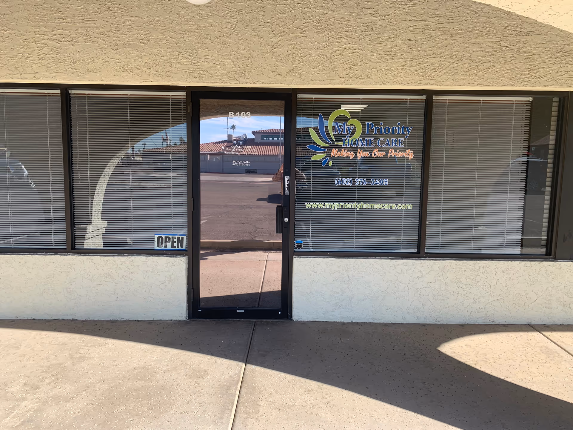 Front view of My Priority Home Care storefront with glass doors, windows, and an OPEN sign.