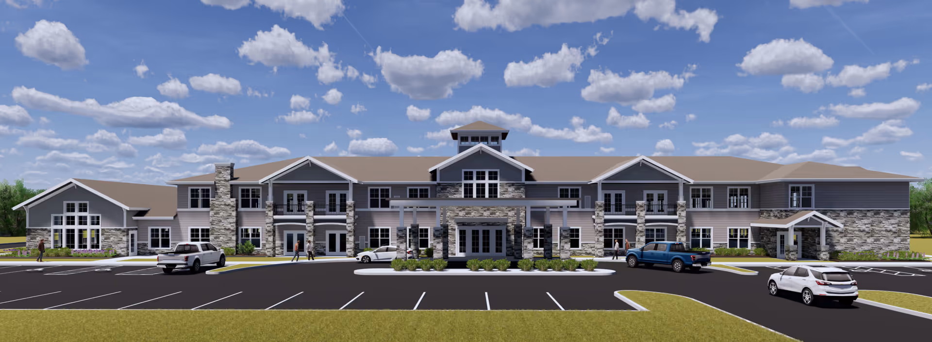 Front exterior view of a large two-story senior living facility building with stone and siding facade, multiple windows, a covered entrance, several parked cars, and a partly cloudy blue sky.