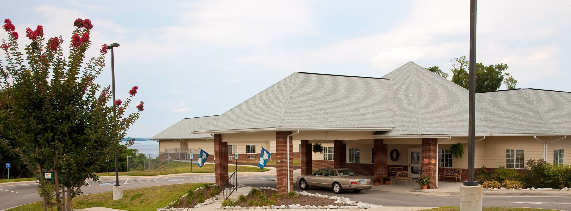 Exterior view of Riverview on the Appomattox Health and Rehab Center front entrance with car.