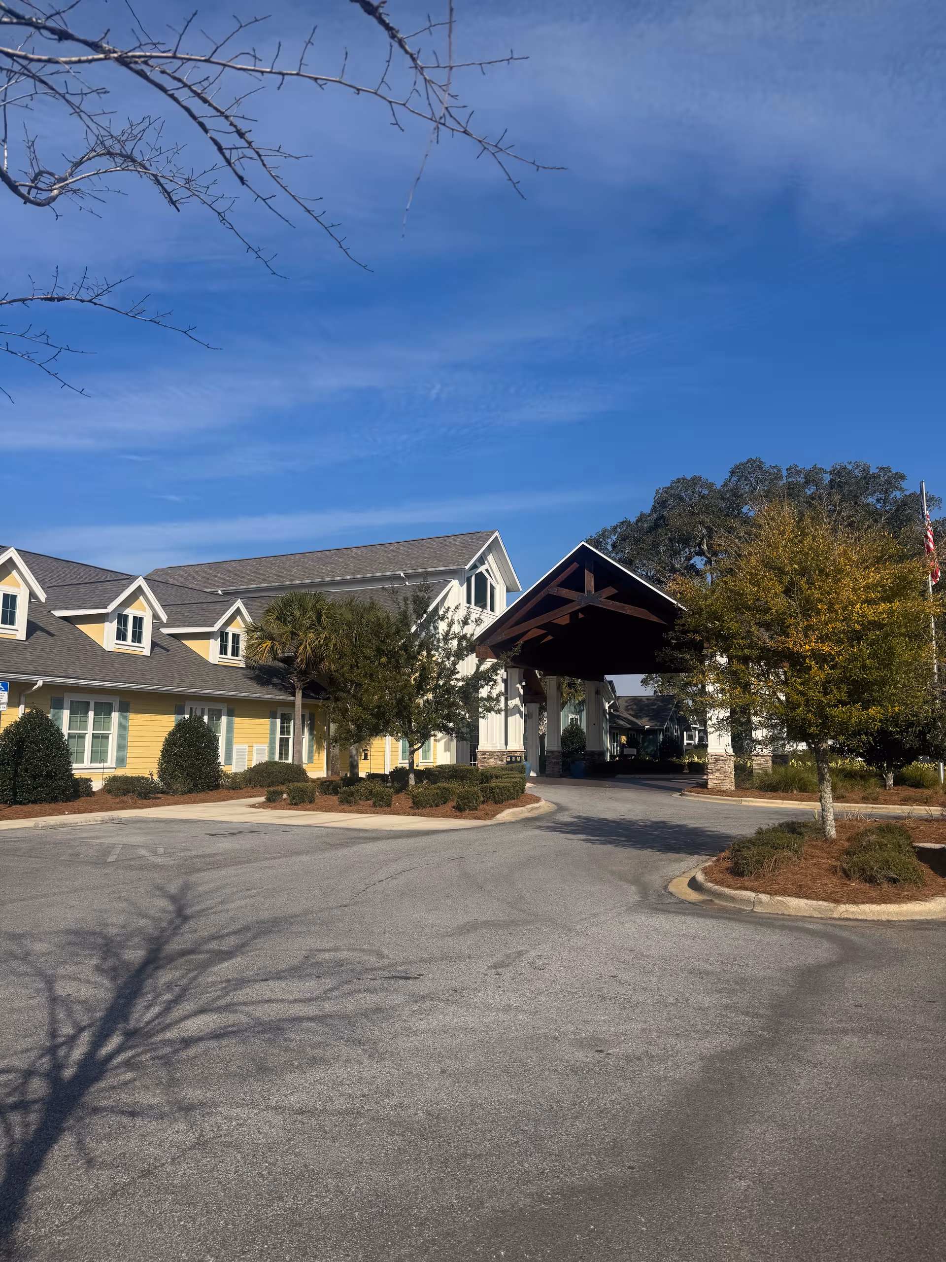 Exterior view of YOURLife of Pensacola with a covered entrance and parking.
