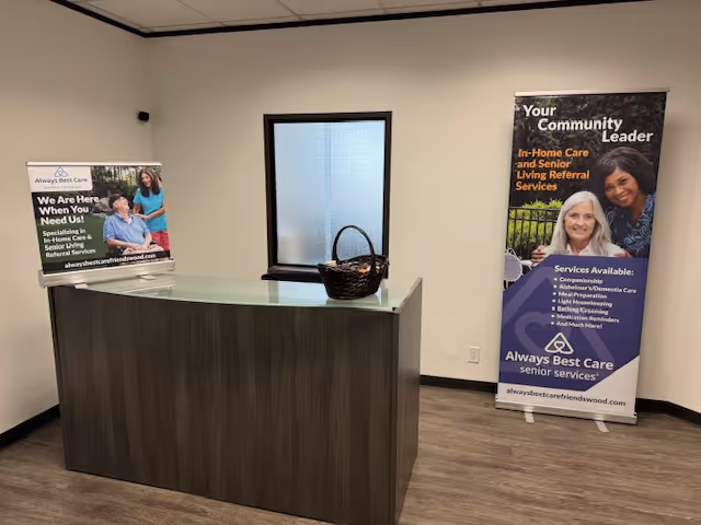 Reception desk in a lobby with banners for Always Best Care Senior Services.